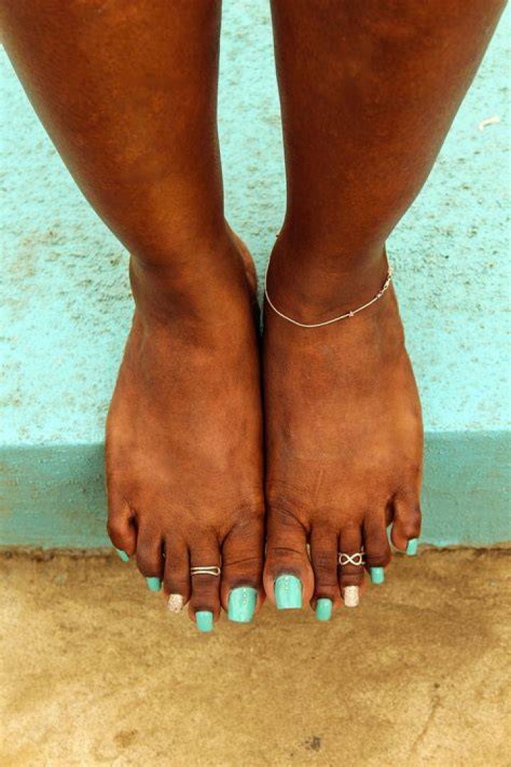 Beautiful ebony feet and toes. I love white polish on pretty toes. One