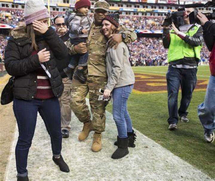 Jessica L. Watkins (left) wipes off her tears as her husband Spc. Leo